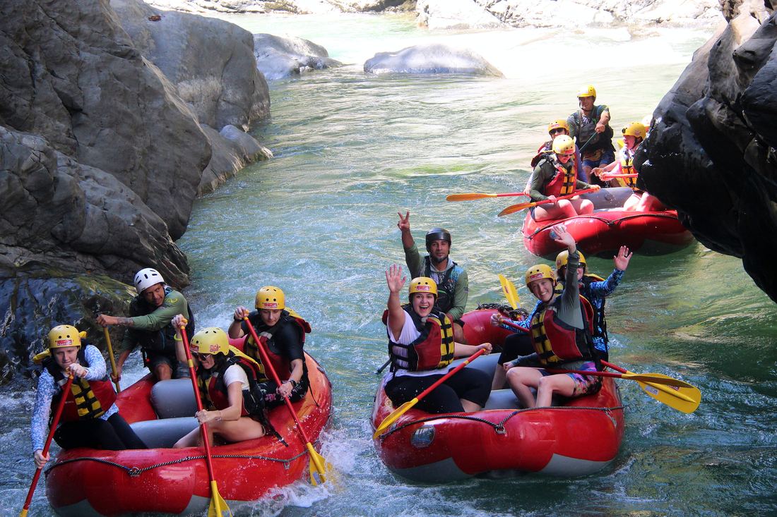 Two rafts resting in a calm pool between the canyon walls