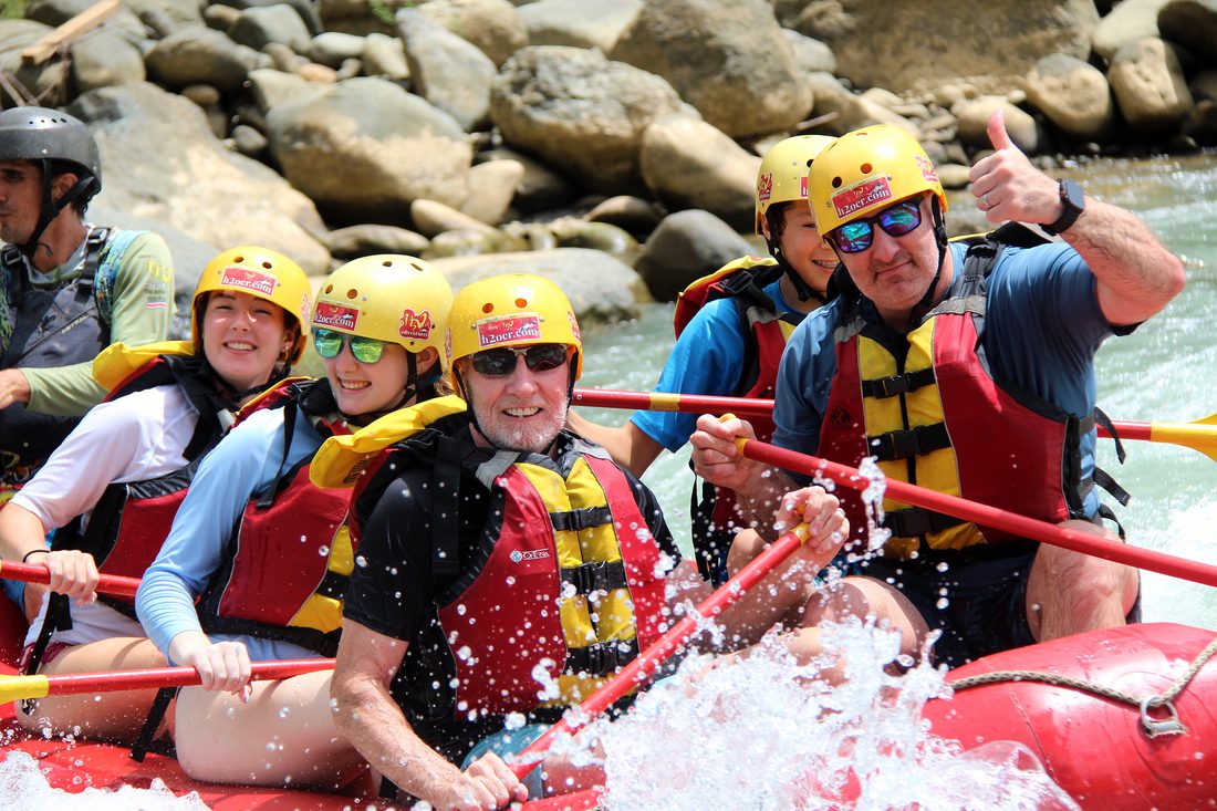 Smiling guests giving a thumbs up in a raft on the Naranjo