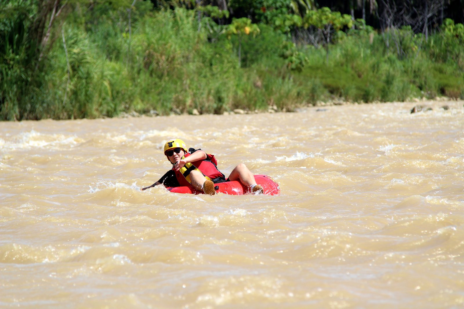A guest leans back in her tube on the lower Naranjo