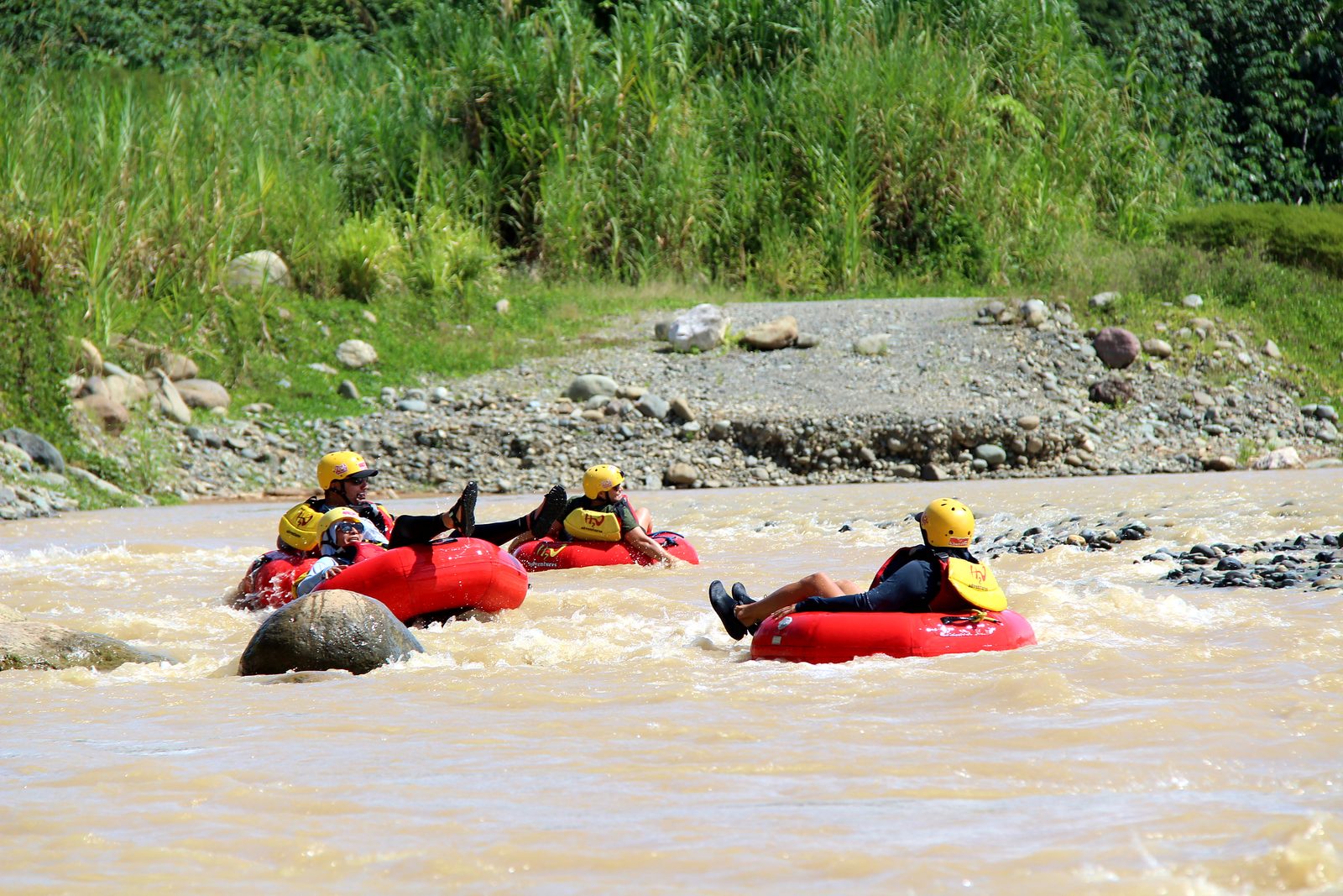 Three guests in tubes among the rocks on the Naranjo