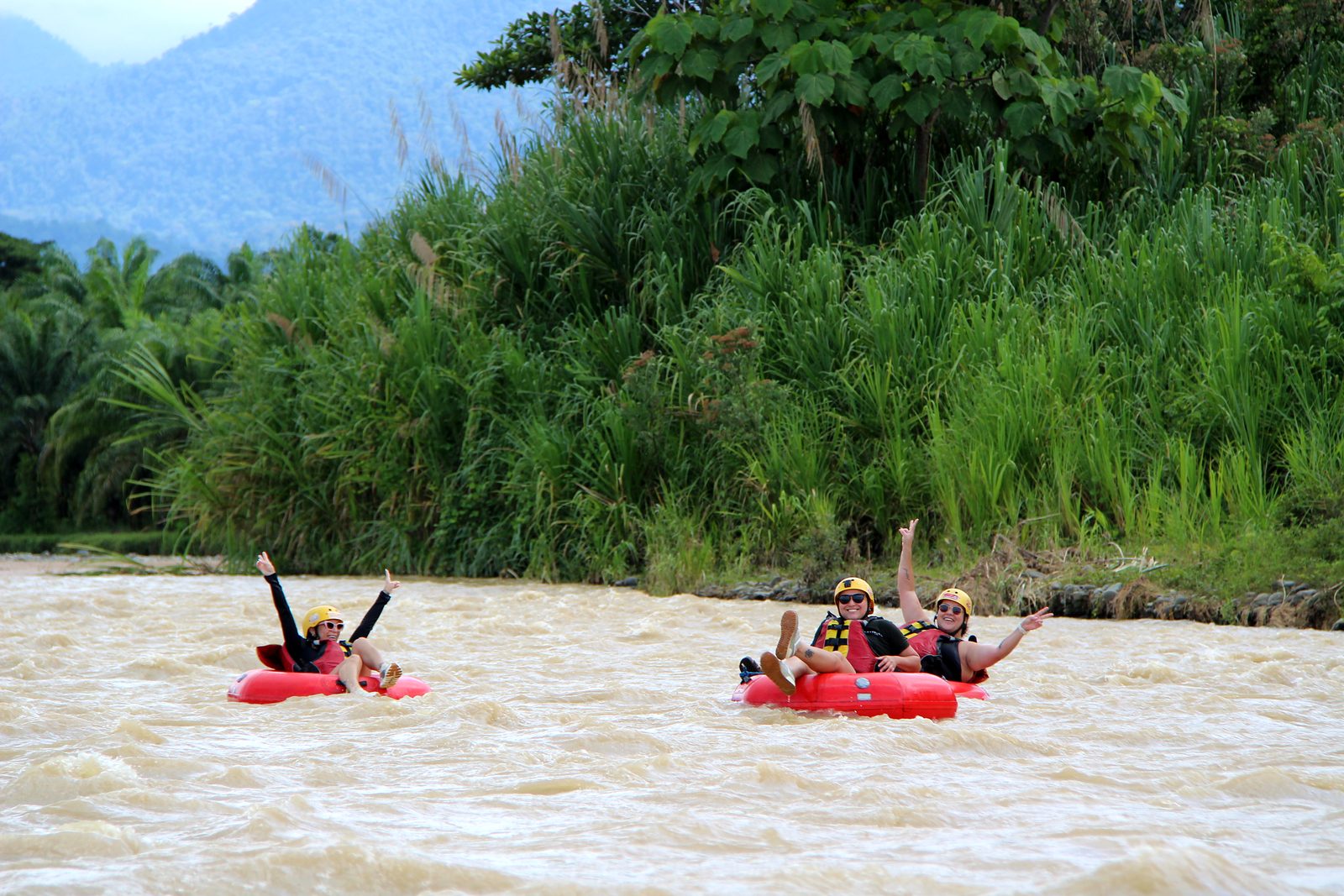 Guests raise their arms in their tubes on the Naranjo
